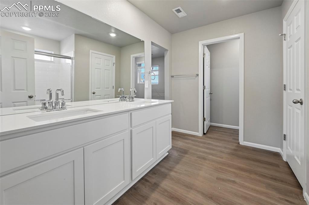 Primary bathroom with standing shower, dual vanity and oversized walk in closet!  