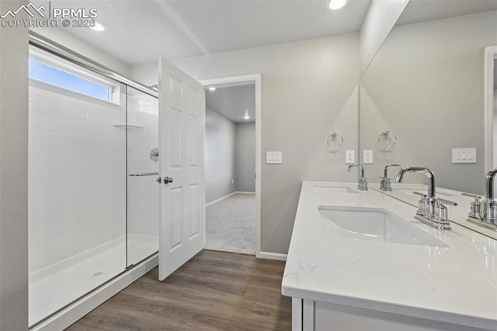 Primary bathroom with standing shower, dual vanity and oversized walk in closet!