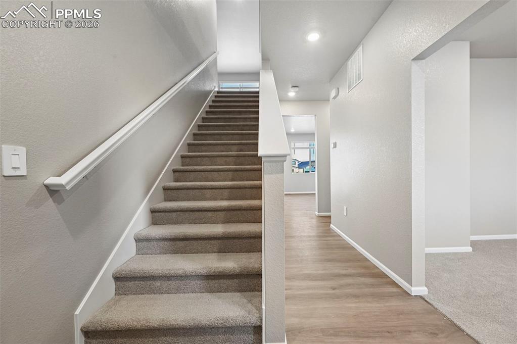Entry, looking into adjacent office and down hall to main floor living