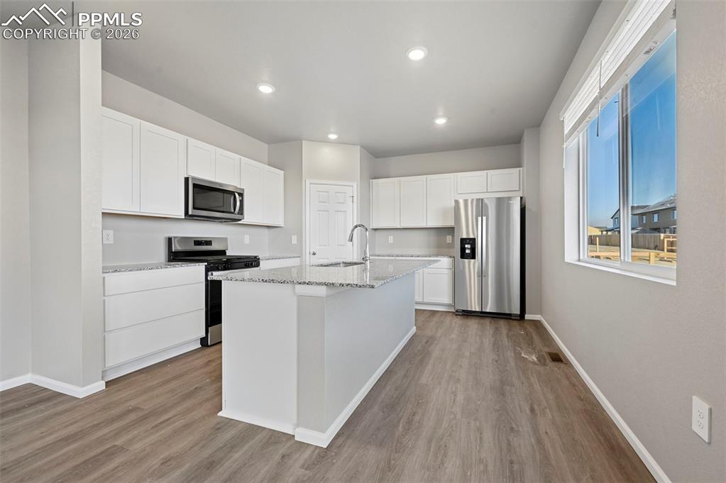 Gorgeous kitchen with stainless steel appliances and granite countertops, with island 