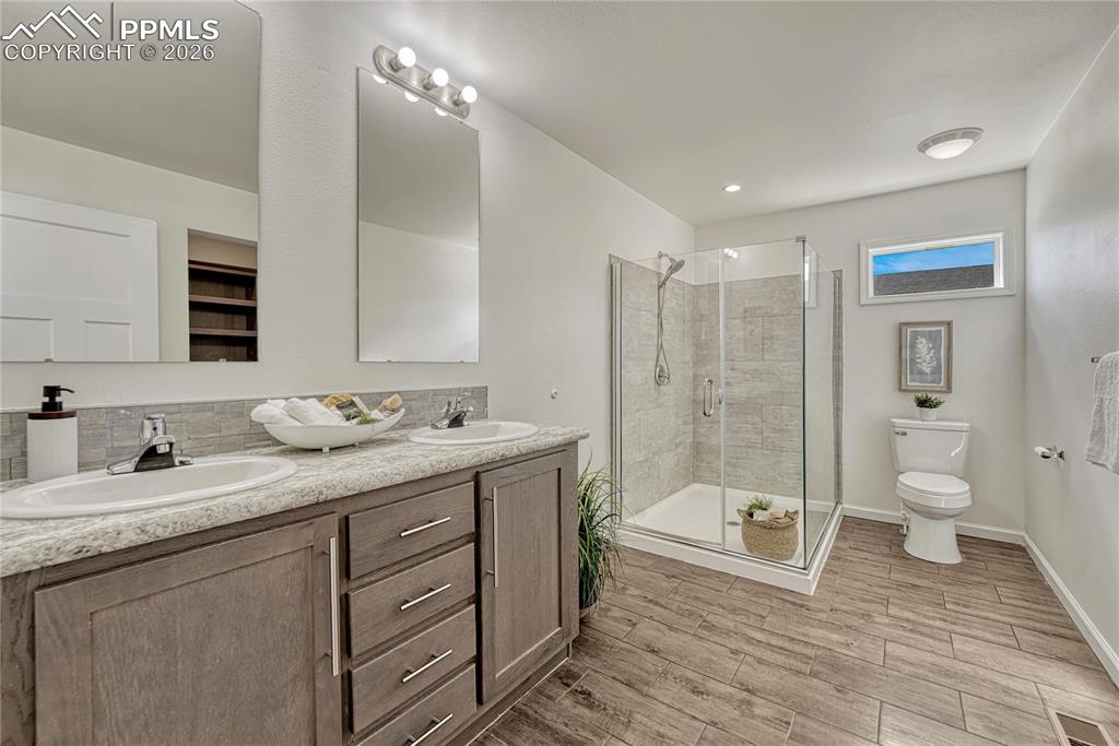 Primary bathroom with dual vanities and large walk-in shower
