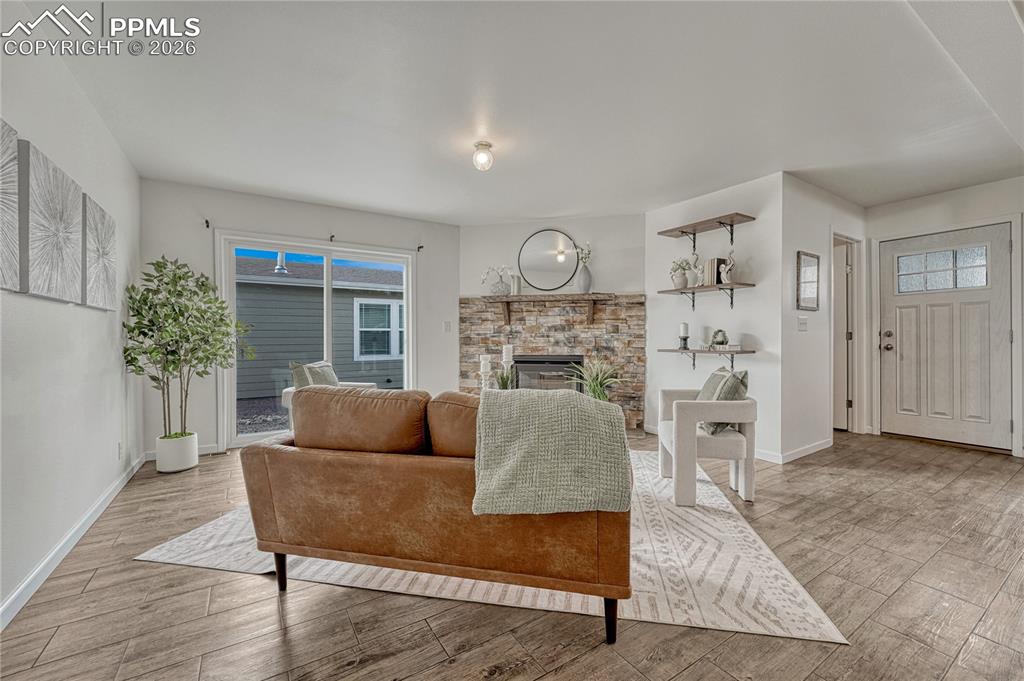 Living room also offers additional shelving to the right of the stone fireplace

