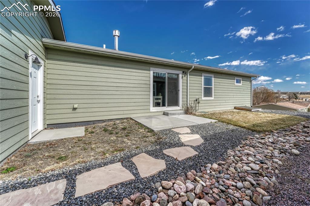 Walk out to the side yard where you have a concrete patio, flagstone walkway to the front and access the the back of the garage
