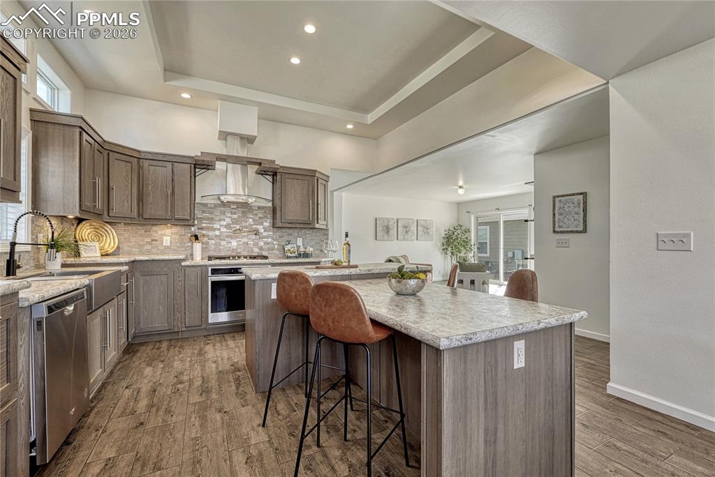 Double sided breakfast bar island and stainless steel whirlpool appliances that can connect to a phone
