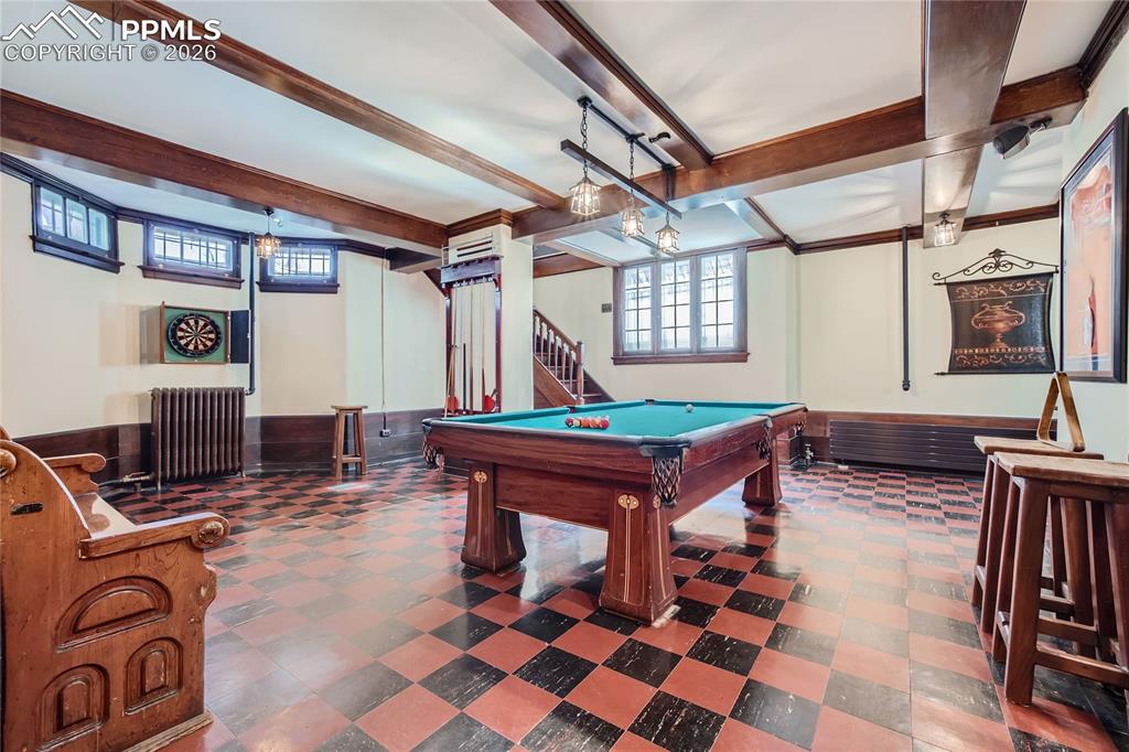 Rec room with billiards, radiator, beamed ceiling, and dark tile floors