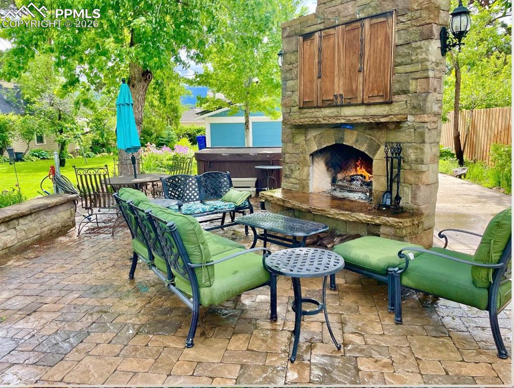 View of patio / terrace with an outdoor stone fireplace, with Gas