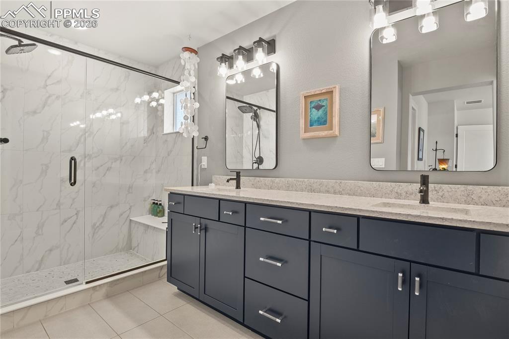 4-piece bath with dual sinks, quartz countertops, and a large walk-in shower