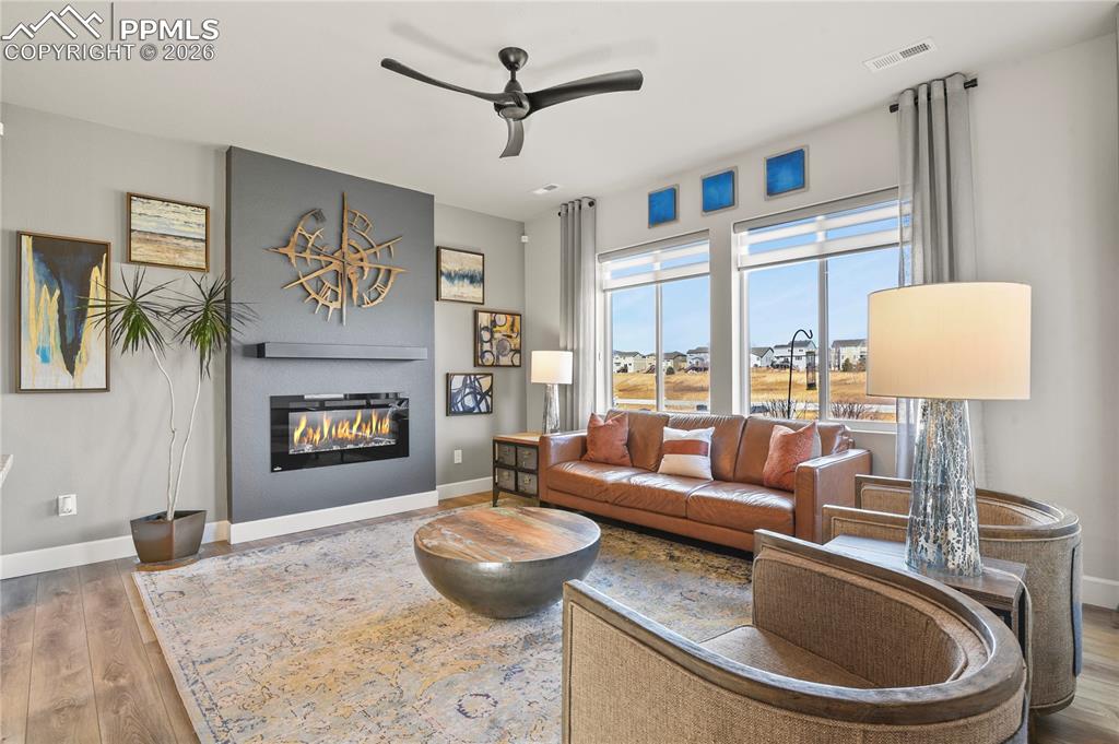 The living room is anchored by a sleek electric fireplace