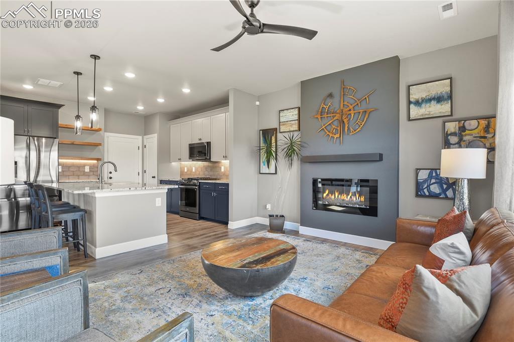 Opens seamlessly to the kitchen and dining areas