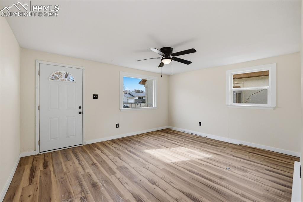 Entryway with ceiling fan and light wood-style flooring