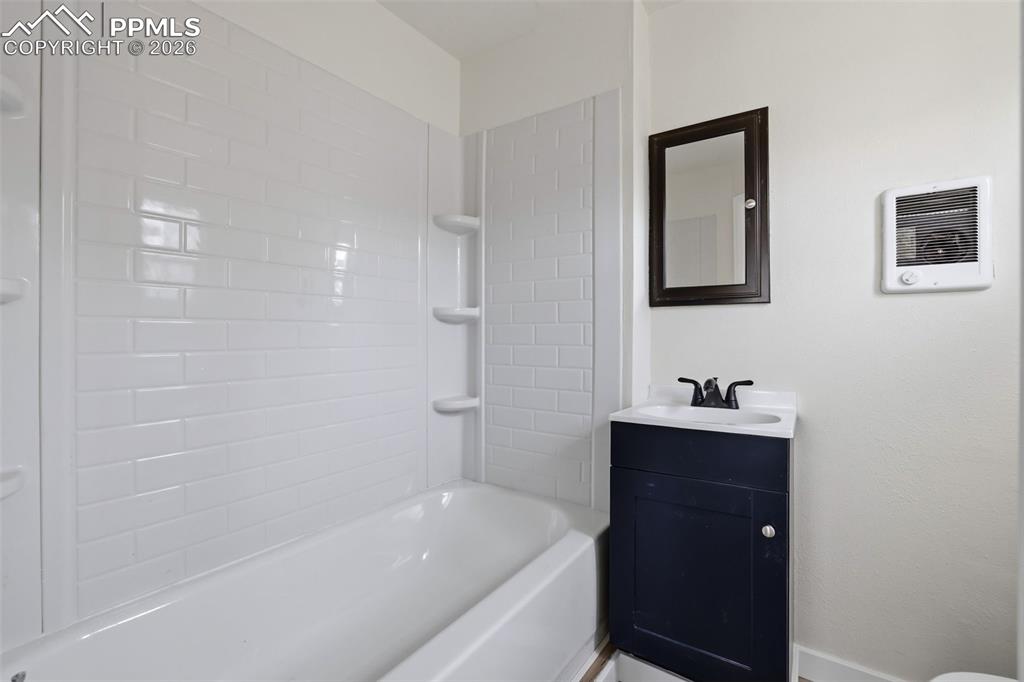 Full bath featuring vanity and shower / bathtub combination
