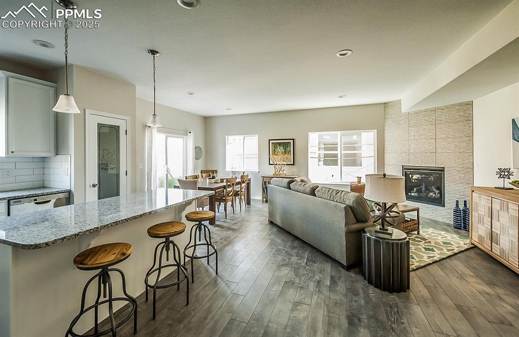 Open concept main level with luxury vinyl floors and gas fireplace. Final finishes will differ.