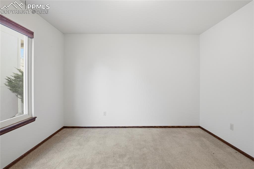 Carpeted spare room with baseboards