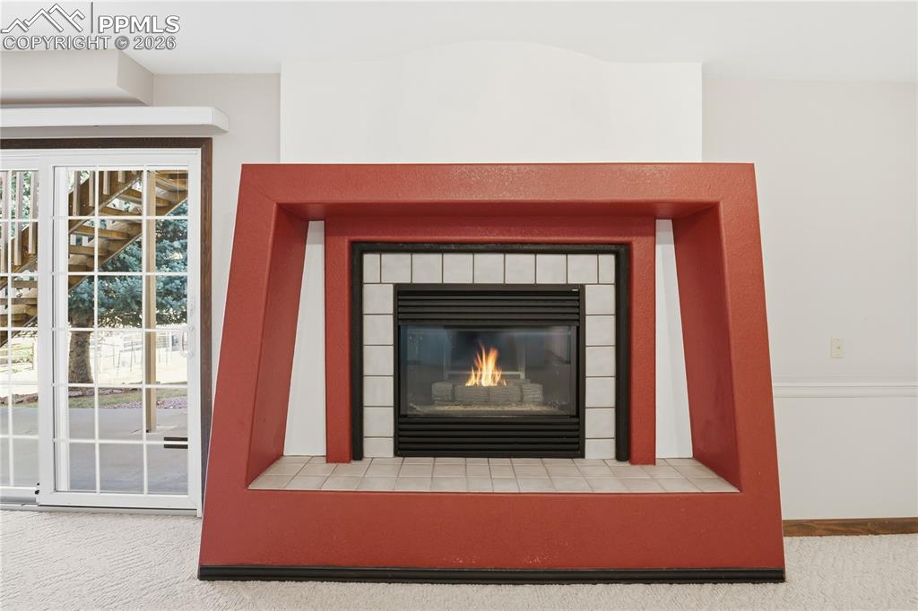 Detailed view of carpet and a tile fireplace