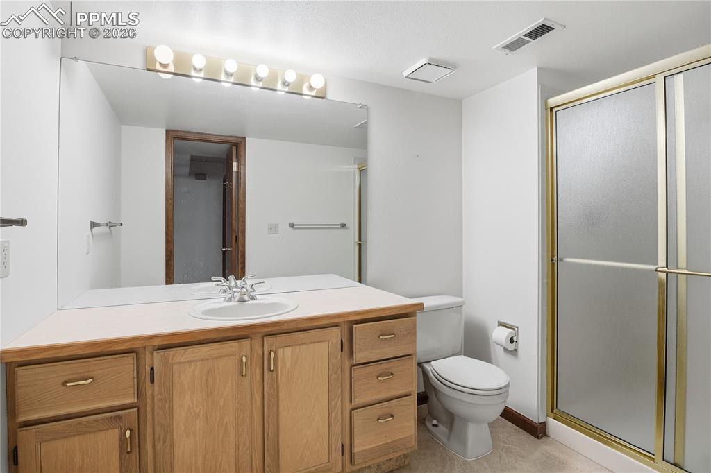 Bathroom featuring vanity and a shower stall