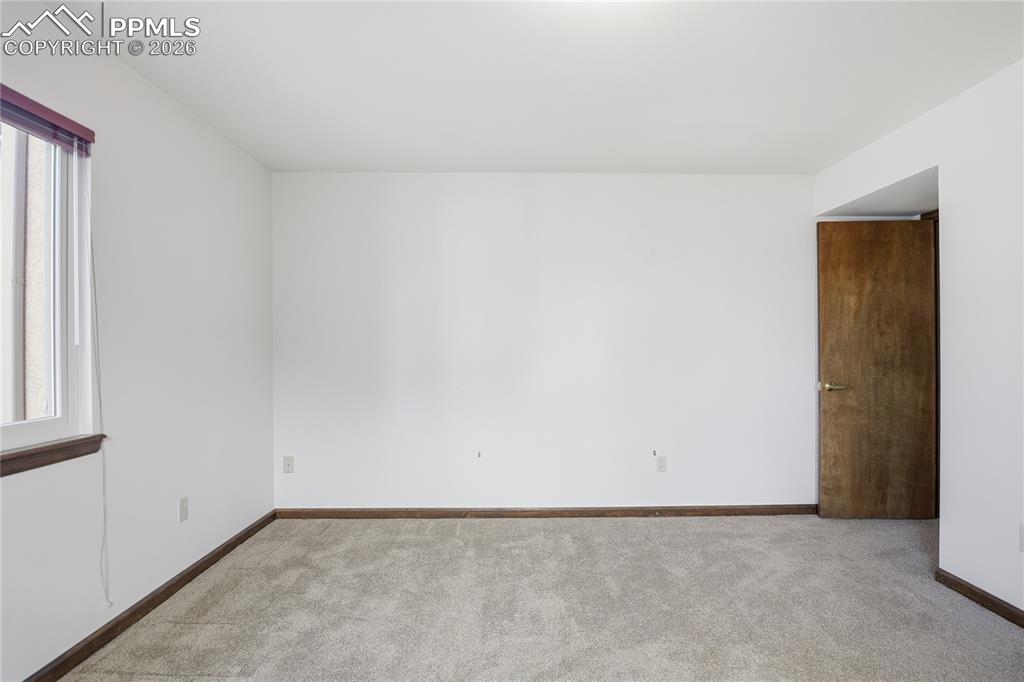 Carpeted spare room with healthy amount of natural light