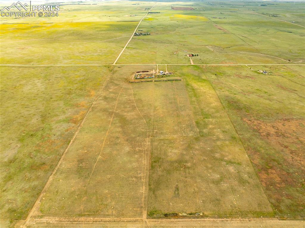 Birds eye view of property featuring a rural view