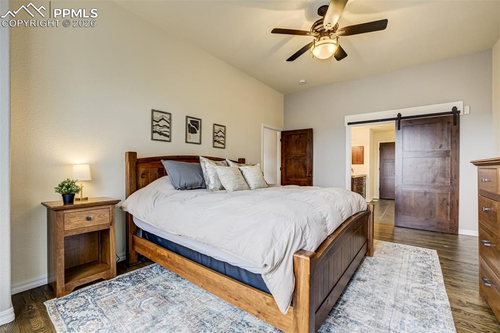 Primary bedroom includes a stylish barn door 