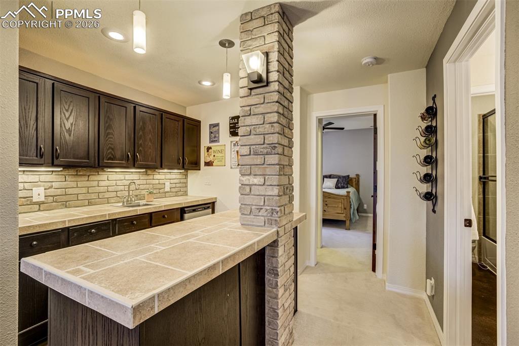 Basement has a large wet bar with ample spae to entertain