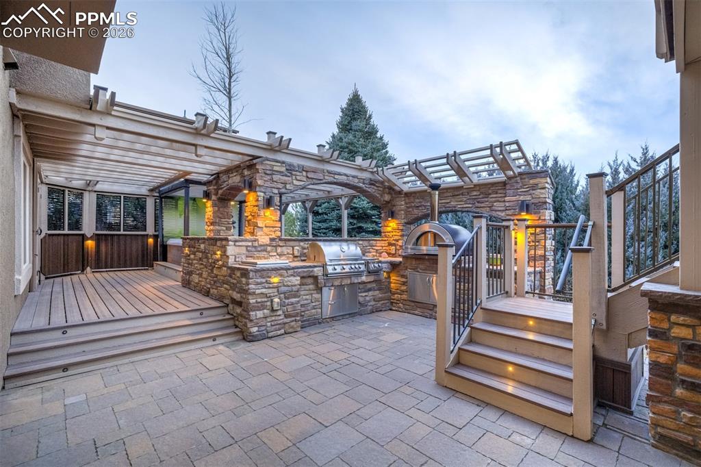 Enjoy cooking in this lovely outdoor kitchen with stainless steel grill and oven