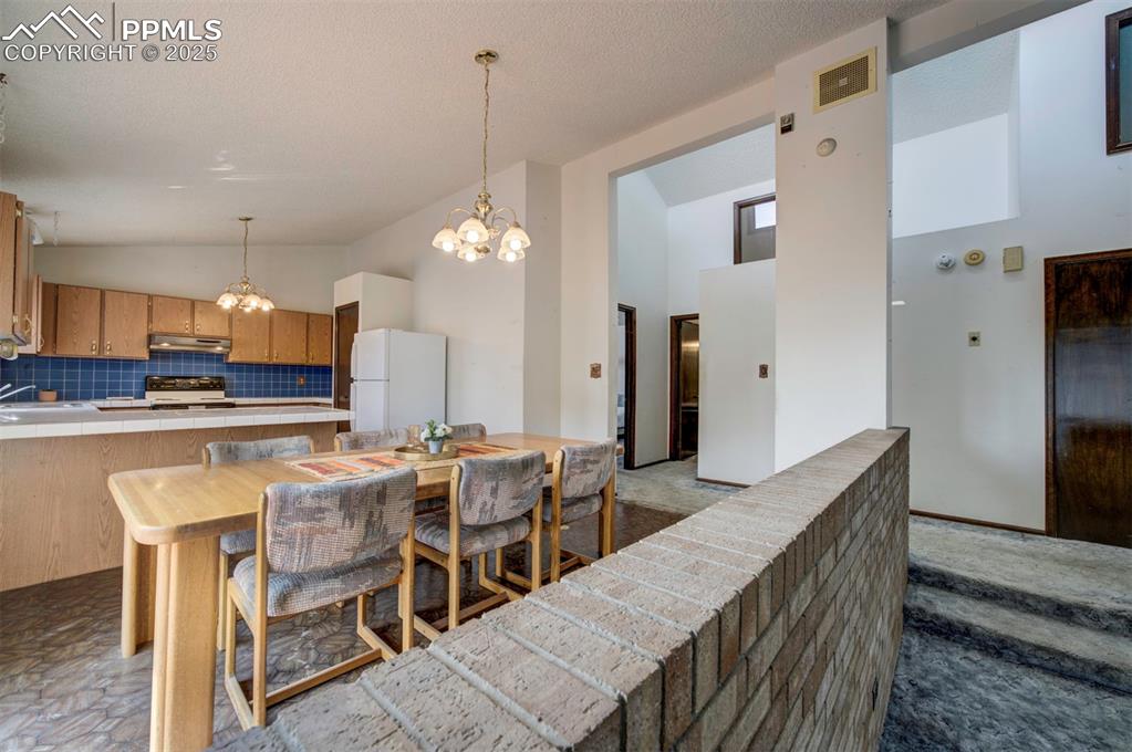 The Living Room and Dining Area/Kitchen are divided by an attractive brick pony wall.