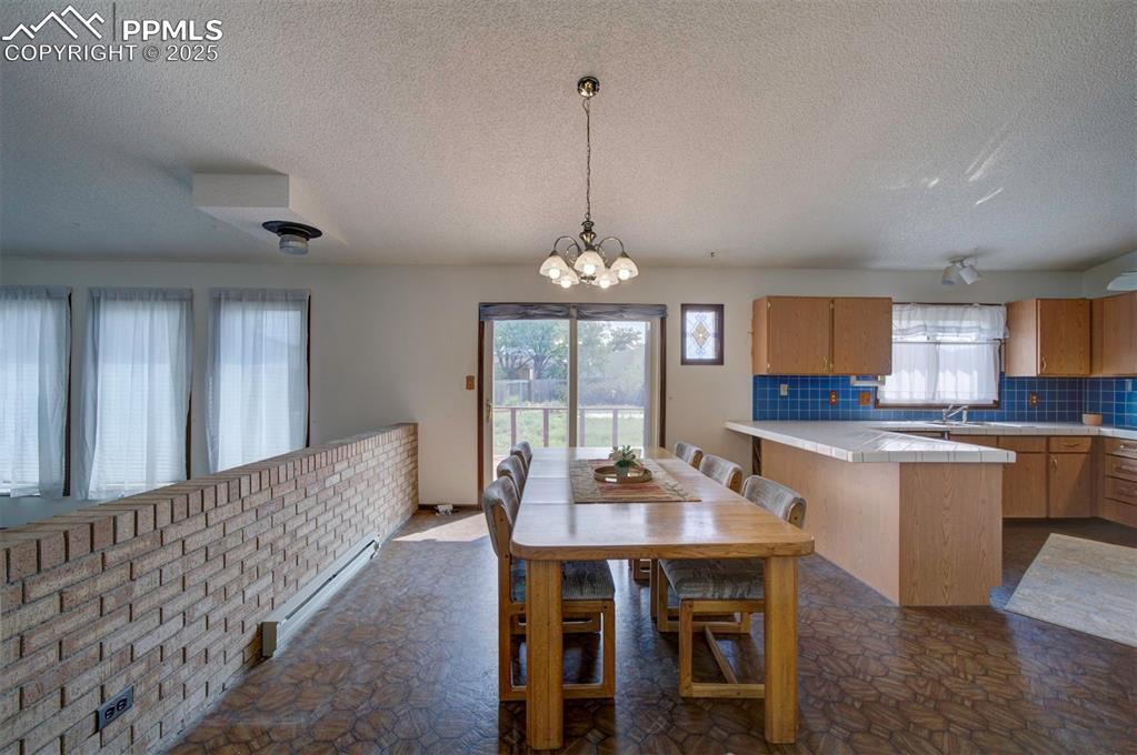 The Dining Area with breakfast bar is conveniently located off the Kitchen making it easy for food service and clean up.