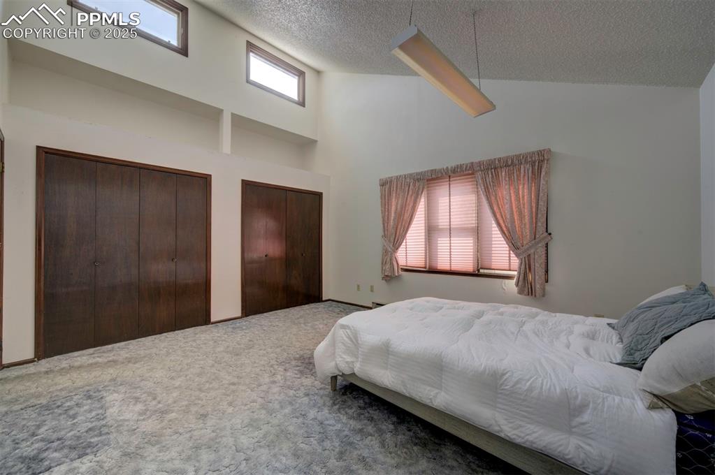 The main-level Primary Bedroom is a tranquil retreat with neutral carpeting, double closets, & an adjoining Full Bathroom.