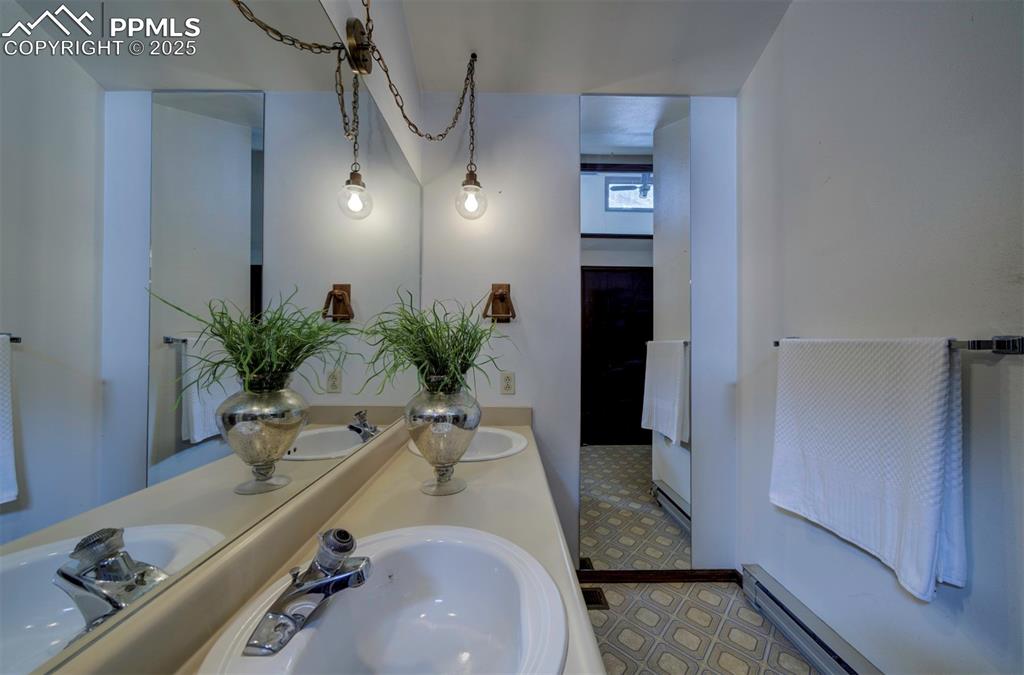 Primary Bathroom with dual sink vanity and extended mirror.