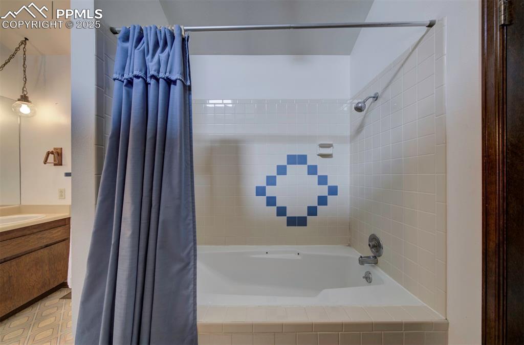 Tiled tub/shower in the main level Primary Bathroom.