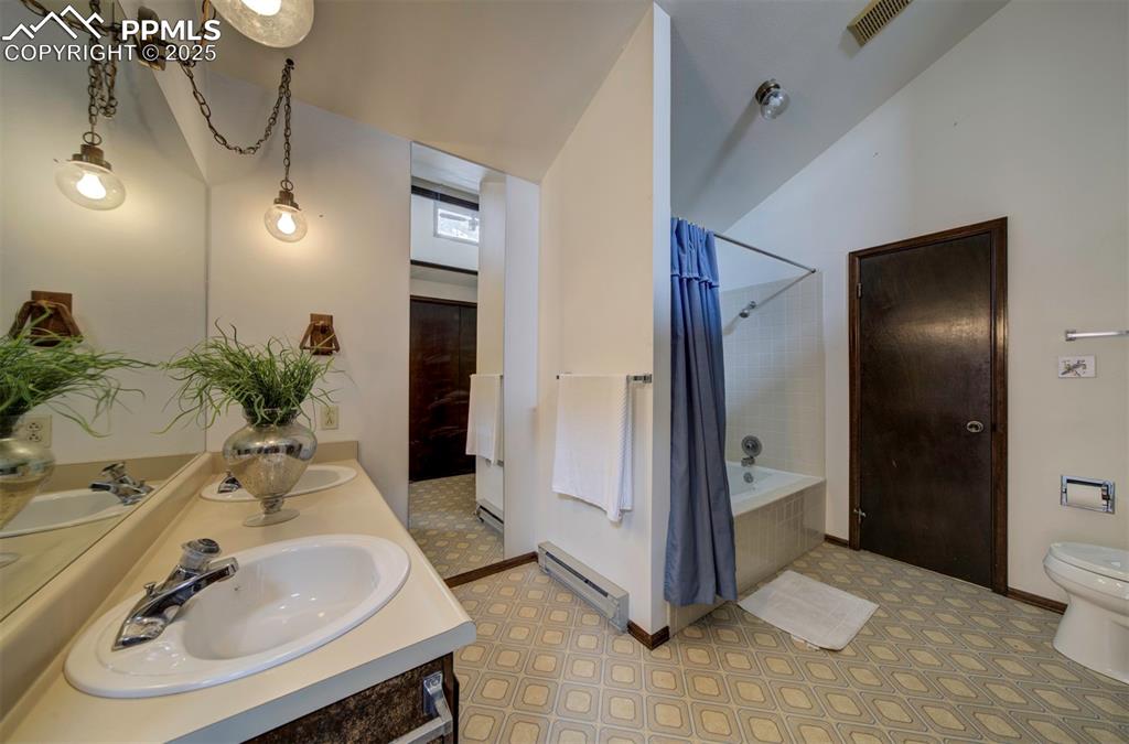Main level Primary Bathroom with vanity, mirror, and tub/shower.
