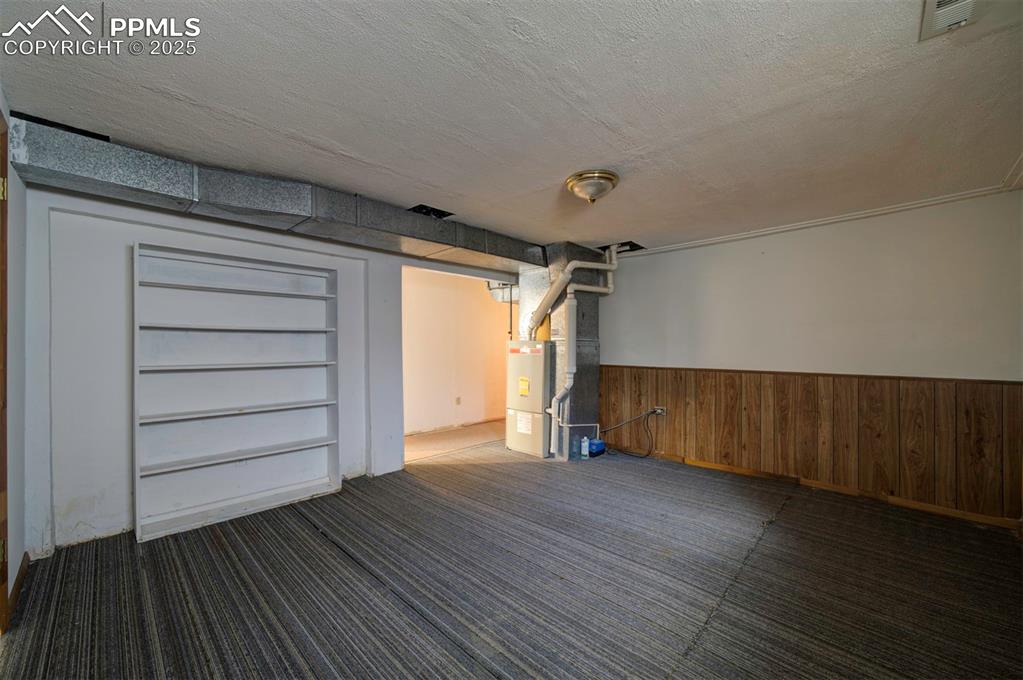 Basement storage room with built-in shelves.