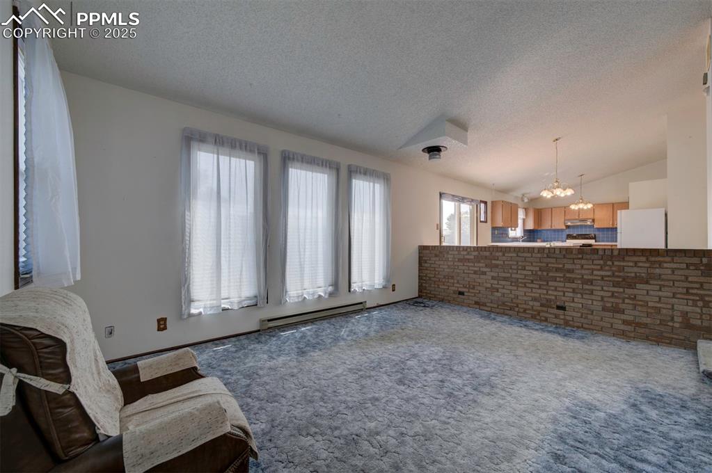 The Living Room has a wall of windows that floods the room with natural sunlight.