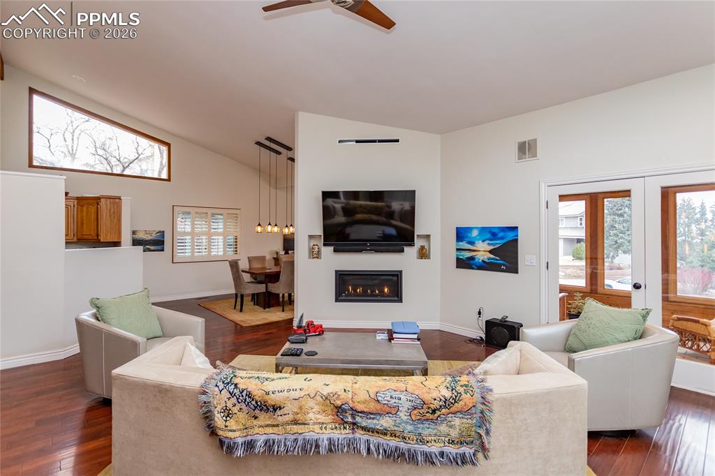 More windows in the living room, ceiling fan, vaulted ceilings - access to the open, airy sunroom.  So inviting.