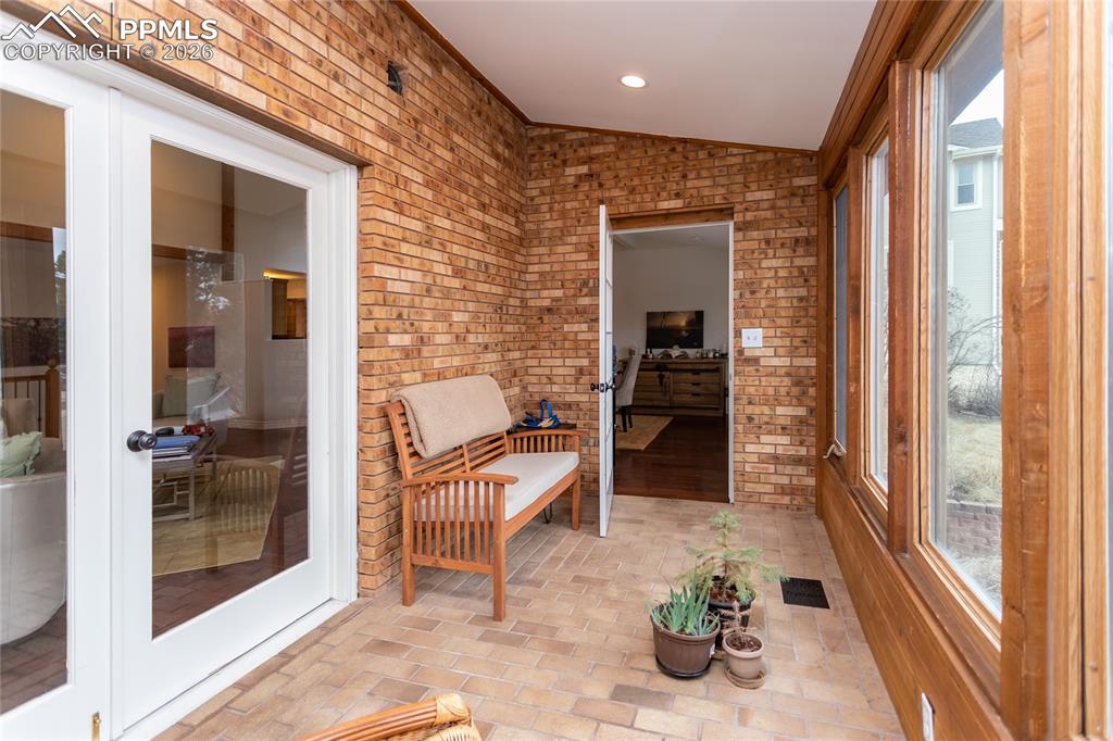 The light filled sun room with floor to ceiling windows accessed from the living room or the dining room is the perfect spot to relax.