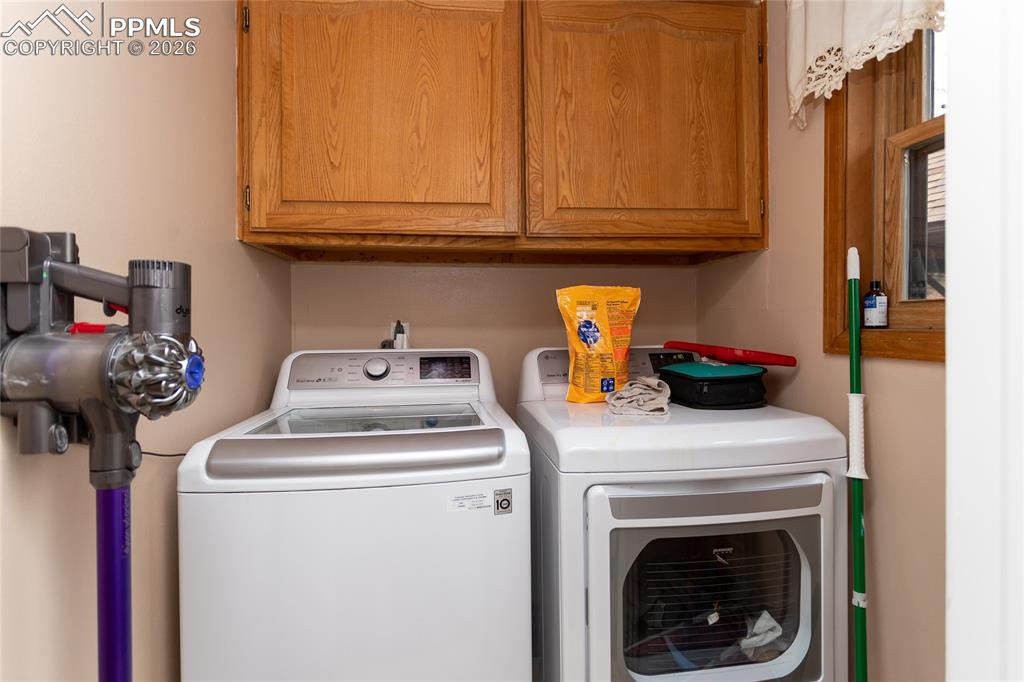 Main level laundry room off of the kitchen with plenty of storage.
