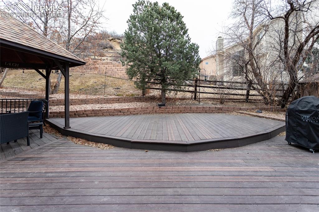 The huge, private, back yard oasis & deck area is surrounded by natural vegetation & rock outcroppings.