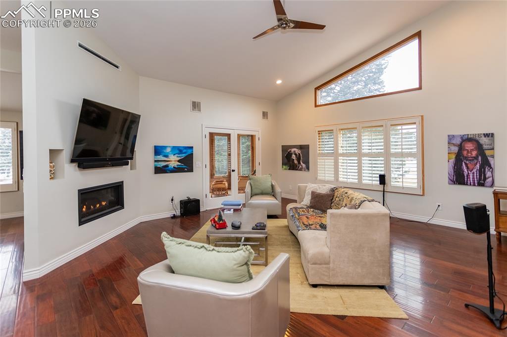 Soaring vaulted ceilings, cozy gas fireplace, open concept, beautiful floors & lots of windows to let in the light.