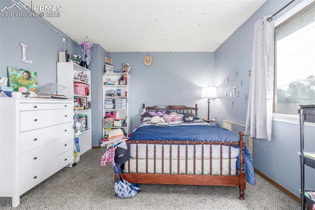Carpeted bedroom featuring baseboards