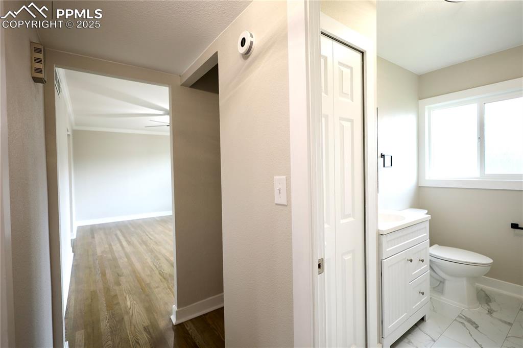 Half bath featuring vanity and baseboards