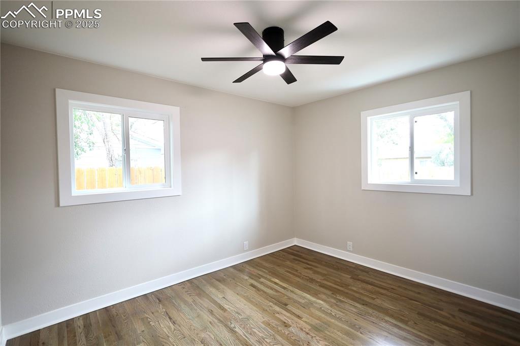 Spare room featuring wood finished floors and ceiling fan