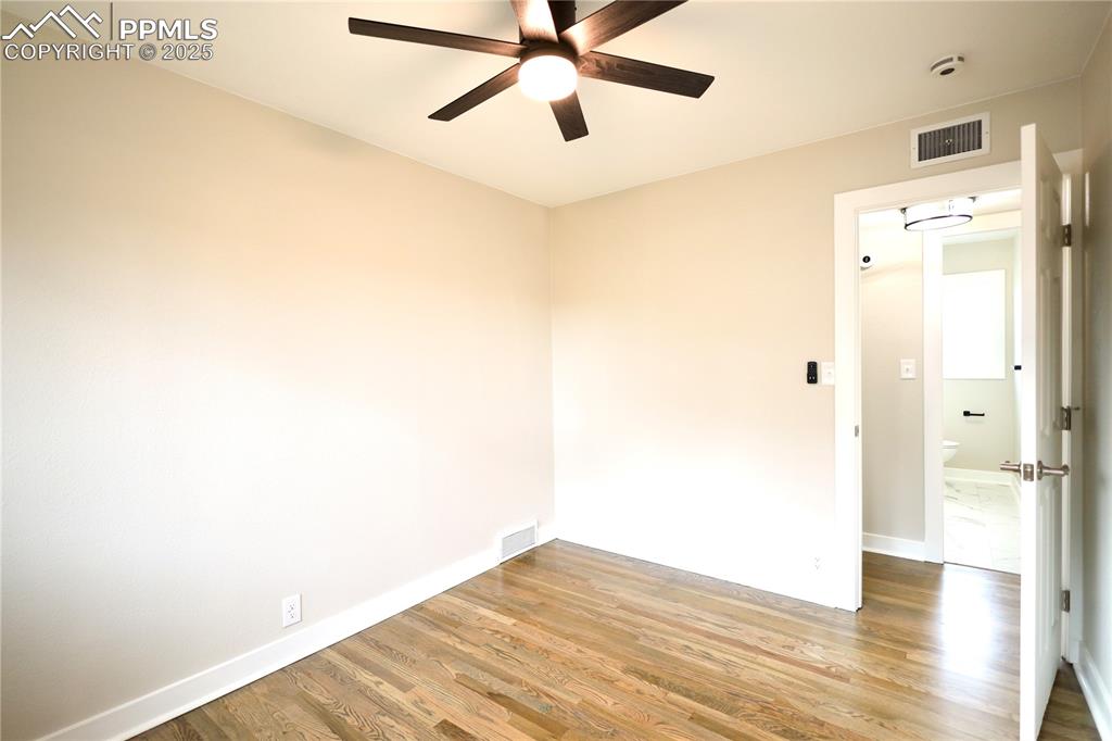 Spare room featuring wood finished floors and a ceiling fan