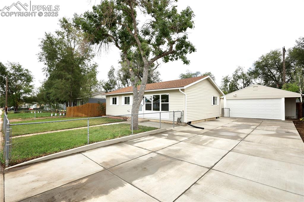 View of front of home featuring an outbuilding, a detached garage, 60 ft Driveway 