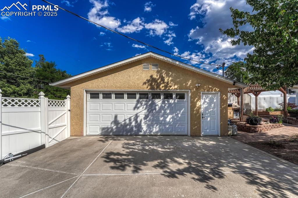 Detached, heated, insulated, lighted oversized 2 car garage with gated alley access