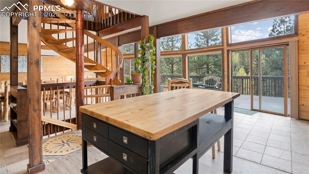 Dining space with wooden walls and stairs
