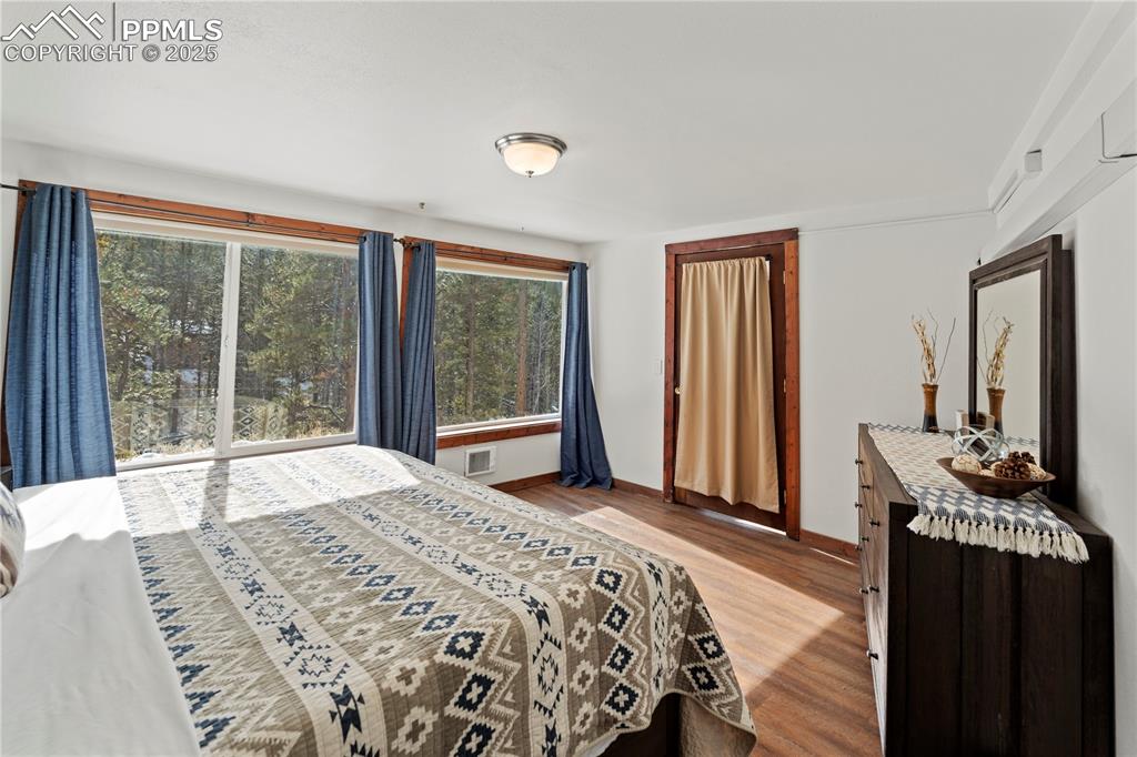Bedroom with light wood finished floors and baseboards