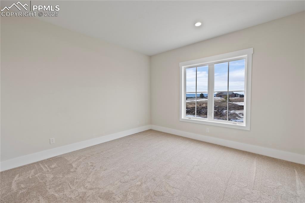Spare room featuring baseboards, recessed lighting, and carpet flooring