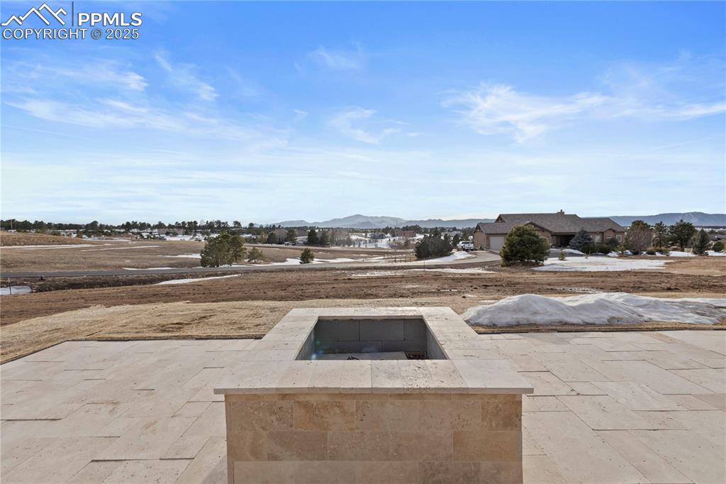 View of patio with a fire pit and a mountain view