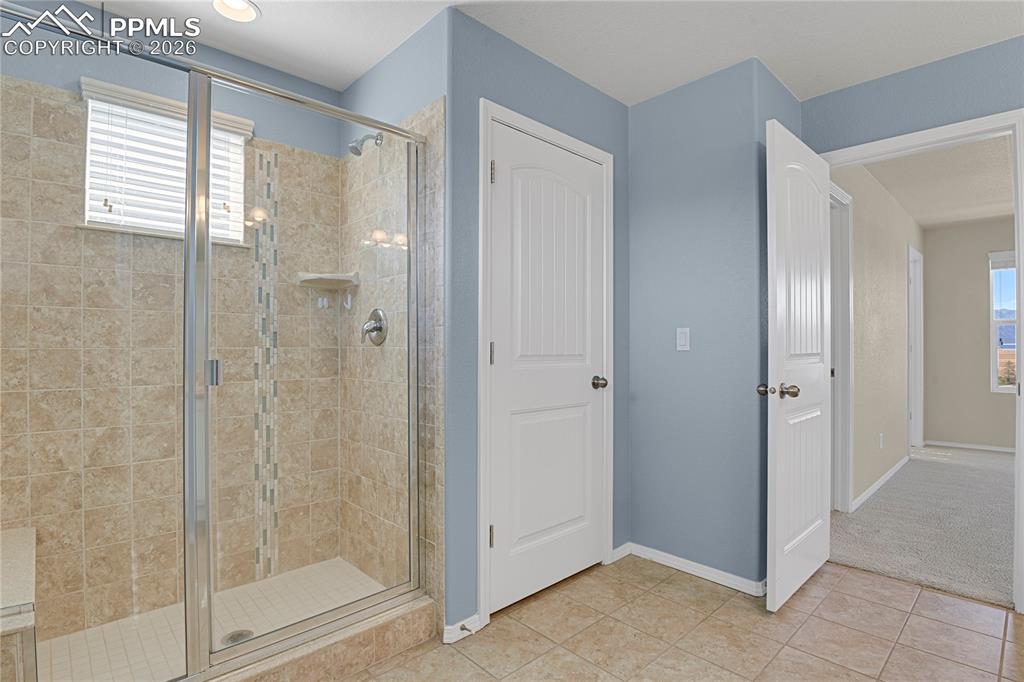 Shower with bench and linen closet for additional storage