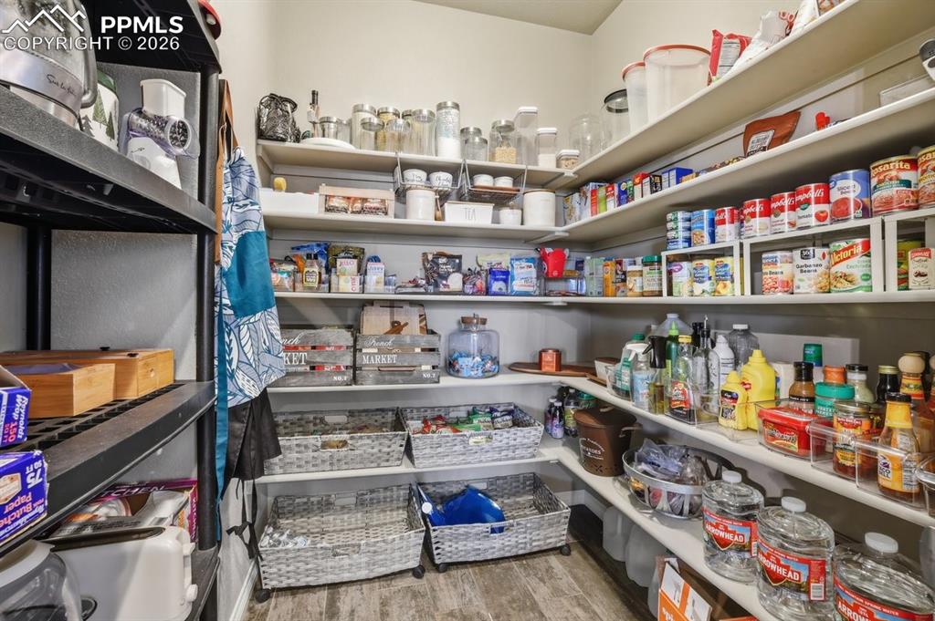 HUGE walk-in pantry with wood shelving