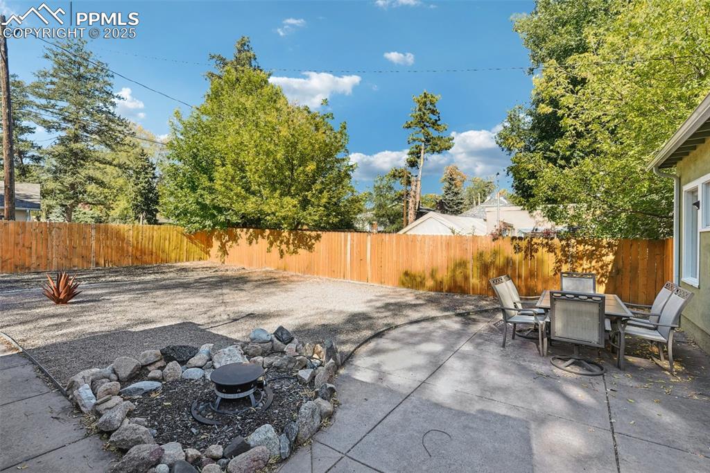 Back patio with fire pit going into the zero maintenance yard!